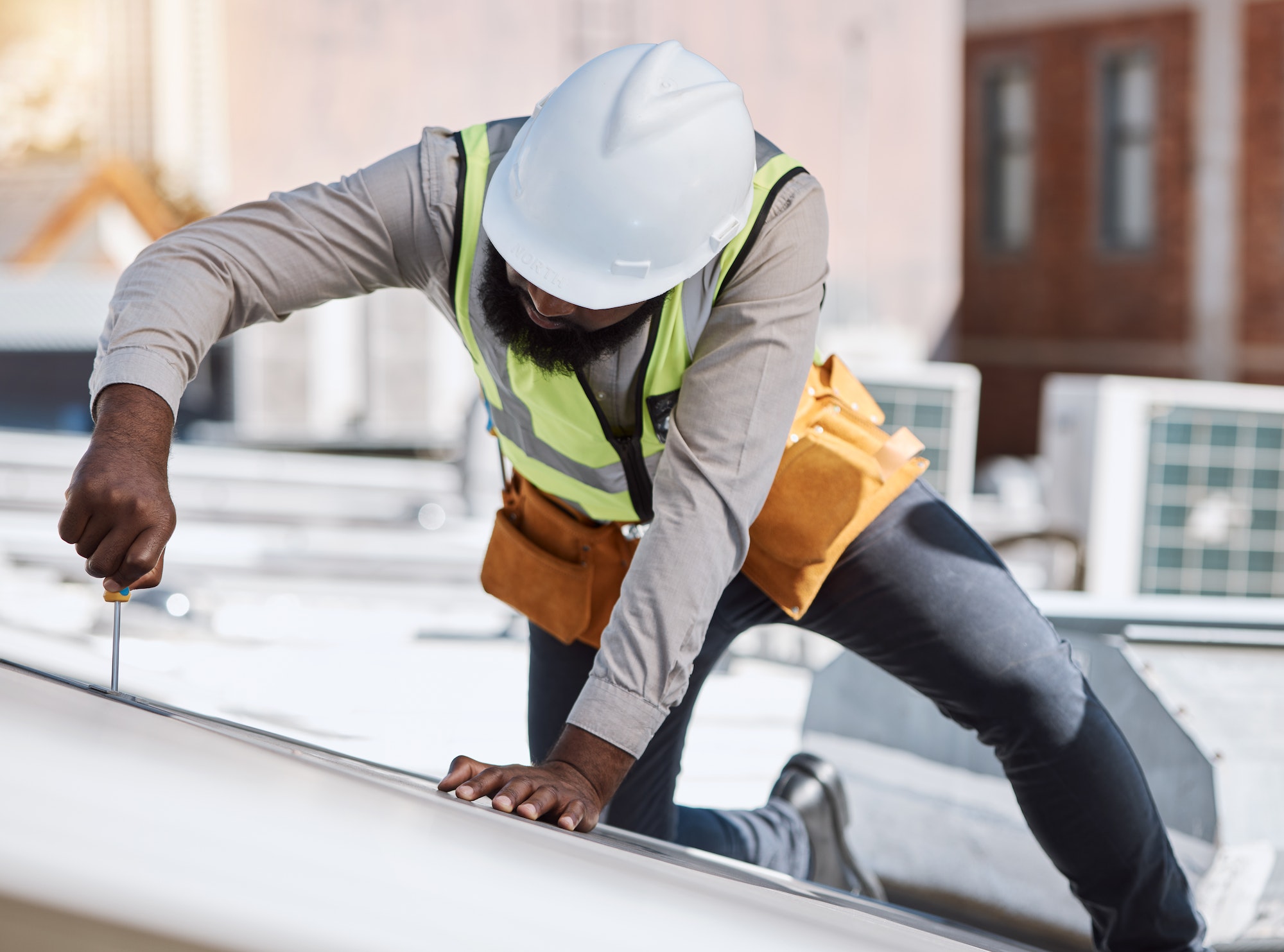 African engineer man, screwdriver and solar energy on rooftop, maintenance and industry for thinkin